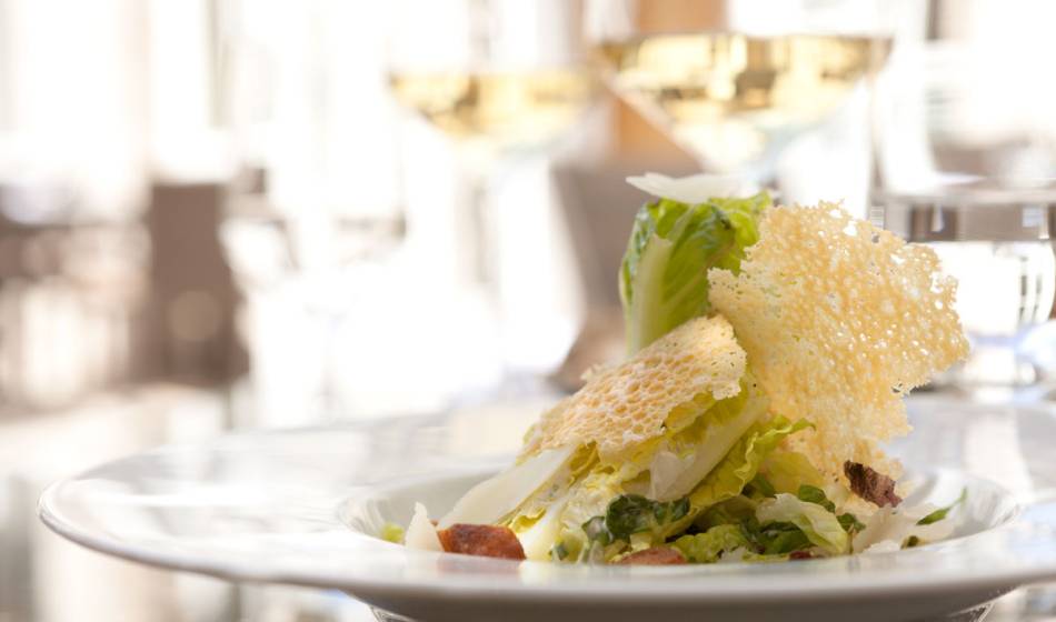 Creatively prepared salad with fresh ingredients and cheese topping in the elegant Hotel Elephant Weimar.
