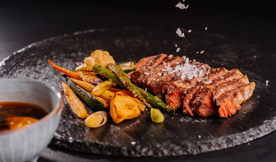 Tender entrecôte, served with grilled vegetables such as carrots and beans, sprinkled with sea salt, alongside sauce in #herrhoshi.