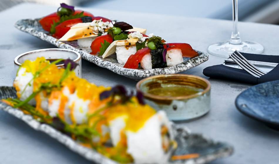 Two plates of artfully prepared sushi and fresh ingredients in the #herrhoshi restaurant in Ahrenshoop.
