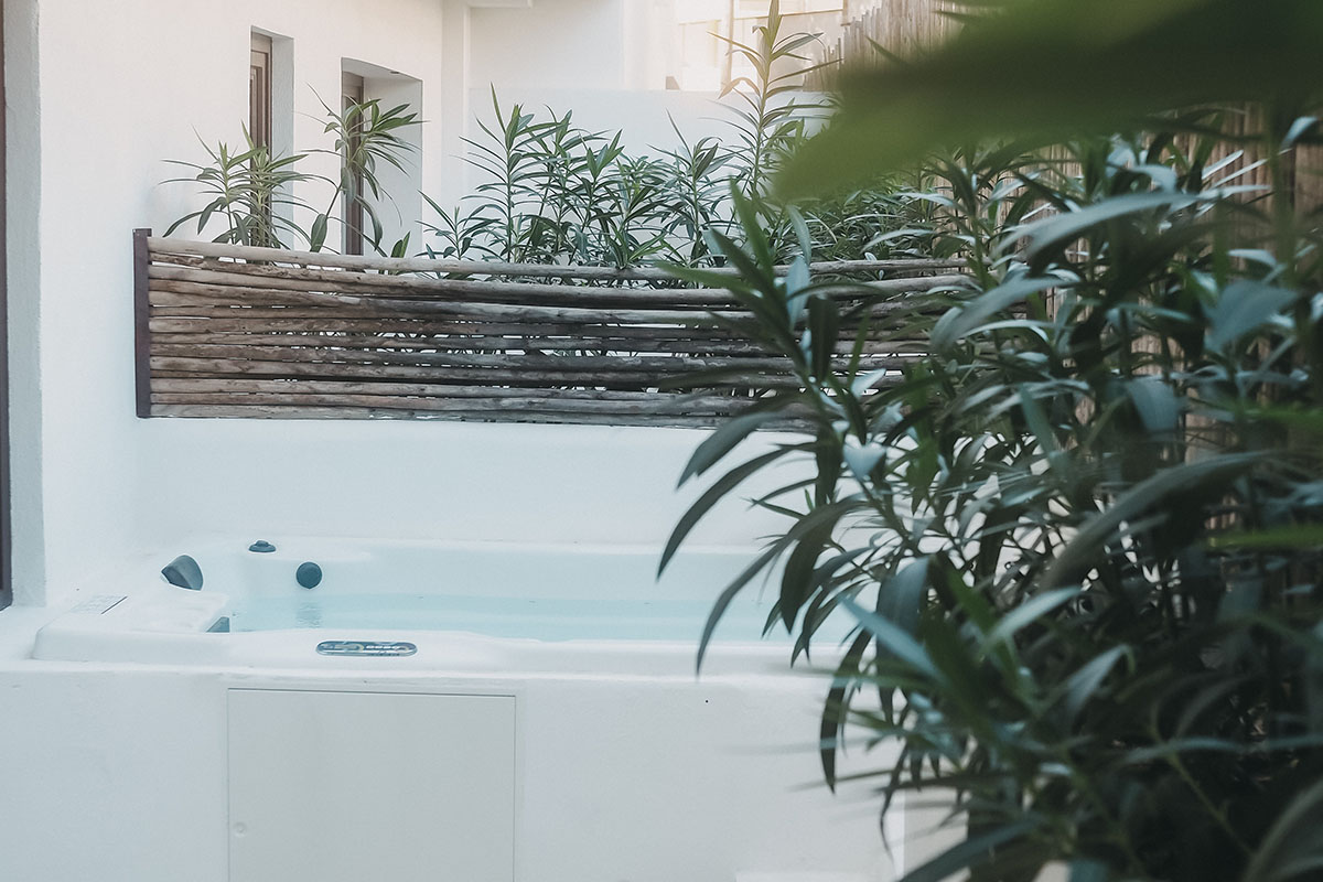 Outdoor whirlpool of the Pueblo room in the Barefoot Hotel Mallorca with natural wood paneling and lots of privacy.