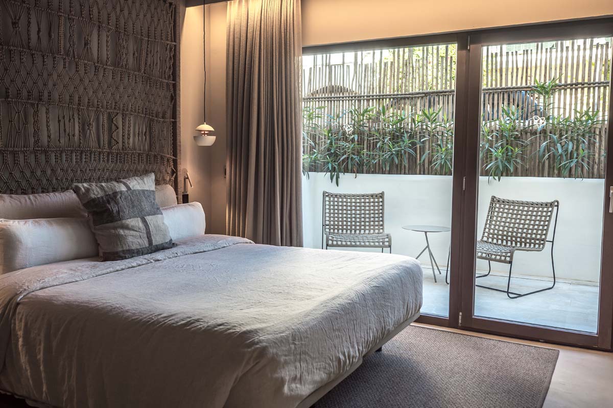 Modern pueblo room at the Barefoot Hotel Mallorca with double bed, large windows and access to the private terrace.