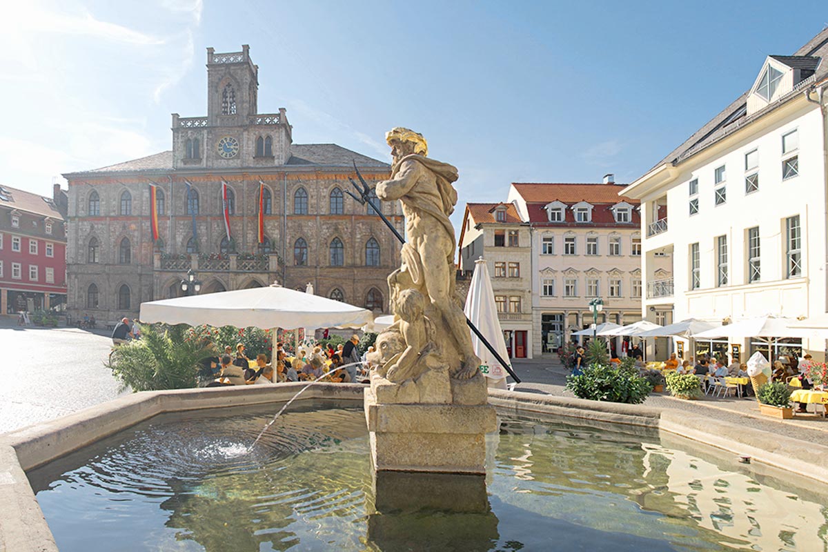 Historic fountain on Weimar’s market square with surrounding cafés and town hall