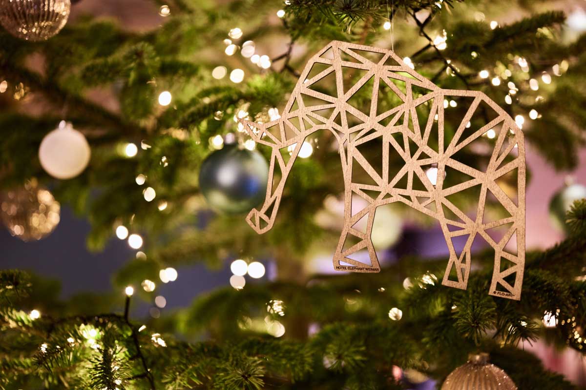 Festively decorated tree with elephant ornament and fairy lights at the Hotel Elephant Weimar at Christmas.