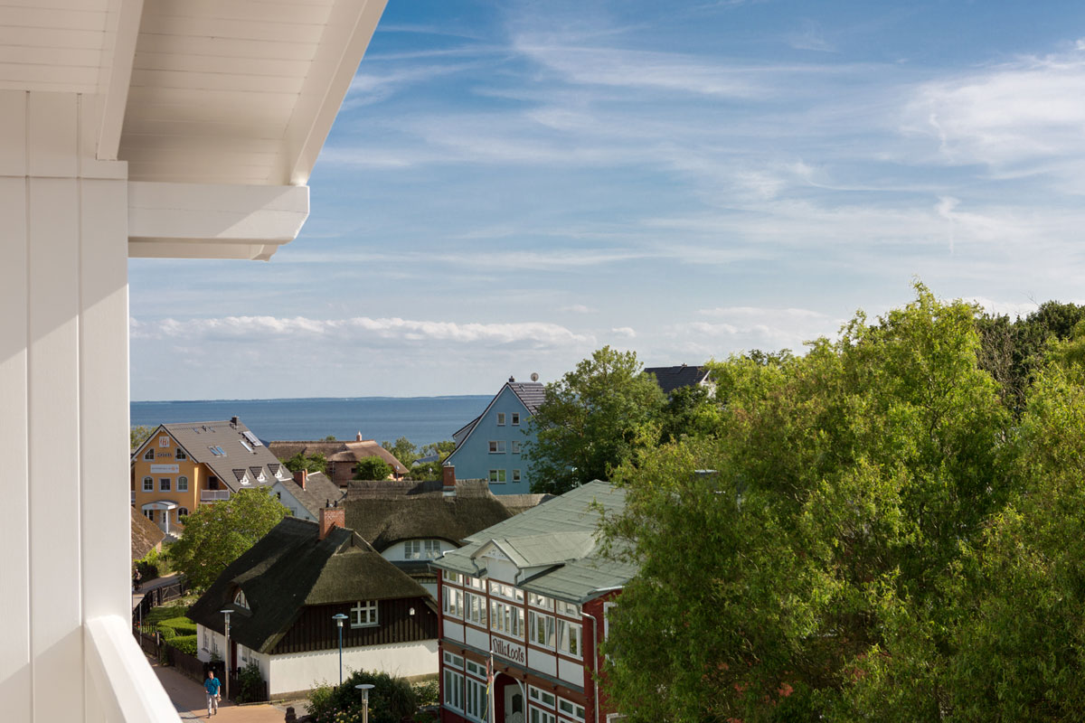Sea view from the room at the Koopmanns Hotel, with picturesque views of houses, trees and the blue Baltic Sea.