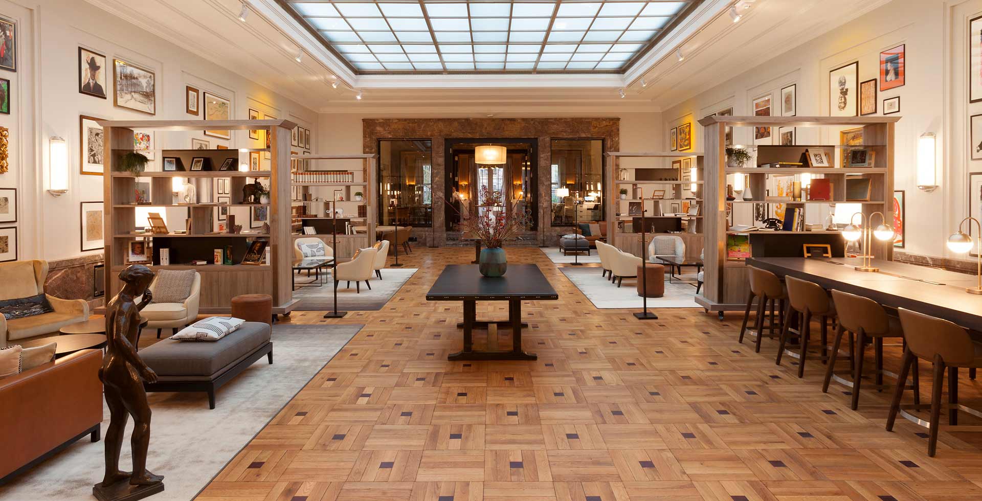 The Lichtsaal at Hotel Elephant Weimar offers a unique atmosphere with its original glass ceiling, artworks, and elegant interior, providing diverse entertainment.