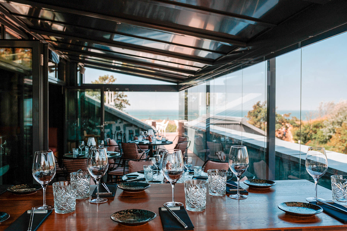 Elegant restaurant for family celebrations with a set table, glasses and sea views in the Seezeichen artist quarter.