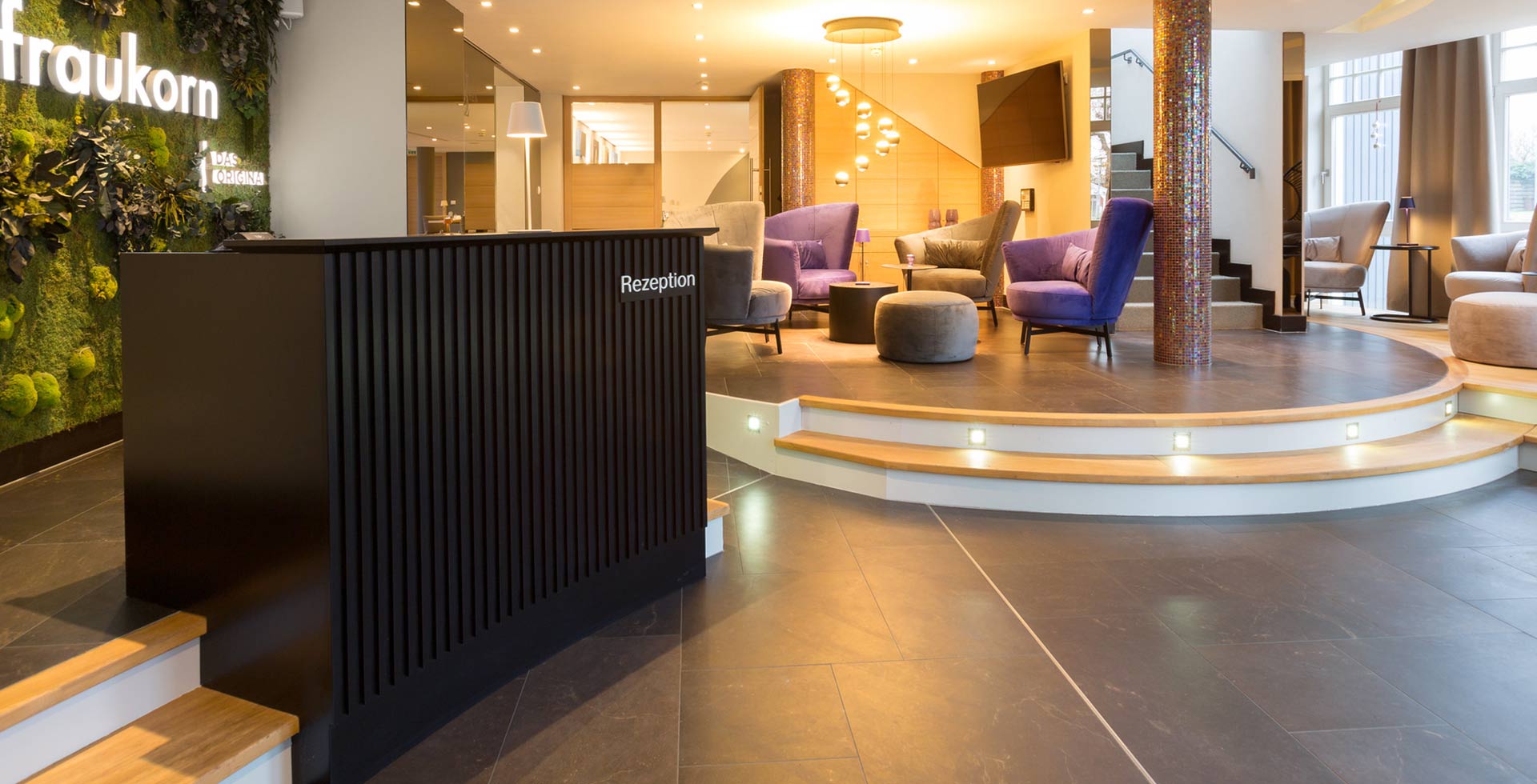 The comfortable lobby with cozy armchairs and modern decor featuring natural elements invites you to linger.