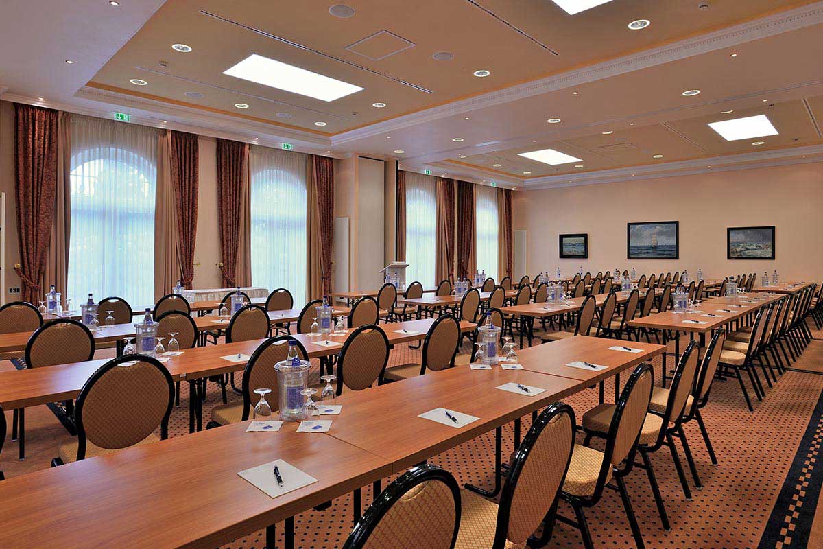 Vju Hotel conference room, equipped with tables, chairs, water and writing materials, ideal for meetings